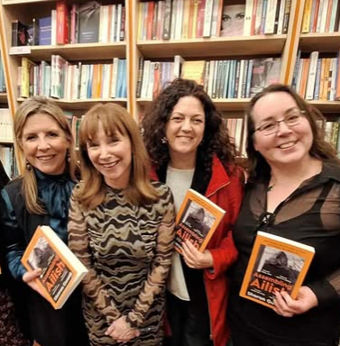 Four women at book launch. Three hold copies of Assembling Ailish.